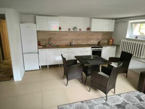 a kitchen with a table and chairs and a refrigerator at Elpo House in Neveronys