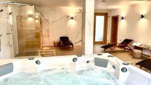 a large bathroom with a tub and a shower at REY Chalet in Vatra Dornei