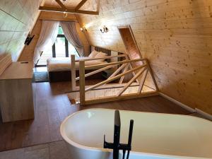 a bathroom with a tub and a bed in a room at Casa Belvedere Pietrosu in Moisei +206 photos