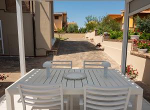 a white table and chairs on a patio at Villa Cattleya in Casciana Terme