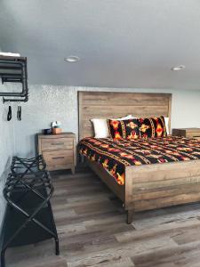 a bedroom with a large bed and a night stand at Stevie Ray In The Hill Country - Hacienda Amor in Johnson City