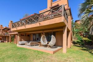 a house with two chairs and a porch at San Lameer Villa 2533 - 4 Bedroom Superior - 8 pax - San Lameer Rental Agency in Southbroom