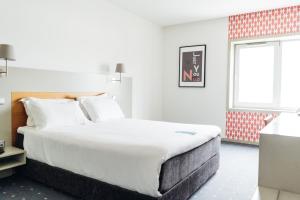 a bedroom with a large bed and a window at Stay Hotel Guimarães Centro in Guimarães +38 photos