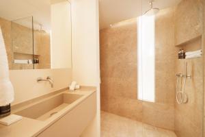 a bathroom with a shower and a sink at Palmares Signature Apartments in Lagos