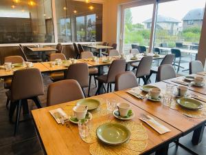 a row of tables and chairs in a restaurant at Equus B&B in Bredene