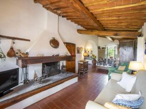 an open living room with a fireplace and wooden ceilings at Holiday Home Il Lamone by Interhome in Ambra