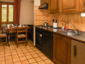 a kitchen with a sink and a stove at Apartment Résidence 35 by Interhome in Champex