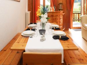 a wooden table with a white table cloth on it at Apartment Résidence 35 by Interhome in Champex