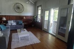 a living room with a couch and a table at Lake summit cabin on the hill Great views with lake in front in Saluda