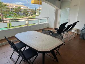 a table and chairs in a room with a balcony at Torresnostra see experience in Torreblanca