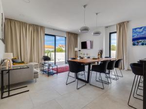 a living room with a table and chairs and a couch at Villa Inizio by Interhome in Brodarica