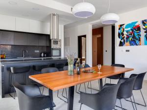 a kitchen and dining room with a wooden table and chairs at Villa Inizio by Interhome in Brodarica +30 photos