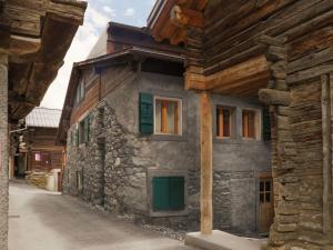 a stone house with green doors on a building at Apartment Les Moulins by Interhome in Verbier