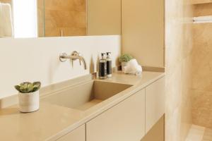 a bathroom with a sink and a counter top at Palmares Signature Apartments in Lagos