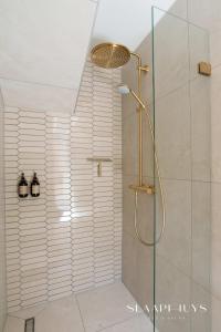 a shower with a glass door in a bathroom at Slaaphuys Bed & Sauna in Alkmaar +25 photos