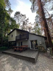 a small house with a deck in the woods at Lawenda in Turawa