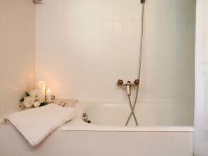 a white bath tub with a towel and candles at Apartment Résidence 25 by Interhome in Champex