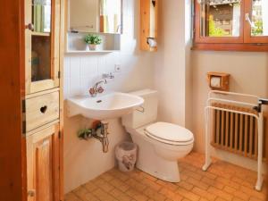 a bathroom with a toilet and a sink at Apartment Résidence 25 by Interhome in Champex