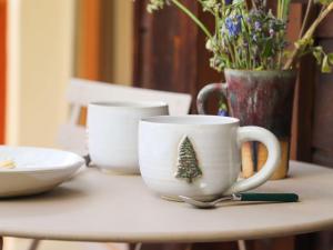 a table with a cup with a christmas tree on it at Apartment Résidence 25 by Interhome in Champex