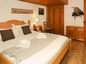 a bedroom with a large bed with towels on it at Apartment Résidence 25 by Interhome in Champex