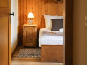 a bedroom with a bed and a table with a lamp at Apartment Résidence 25 by Interhome in Champex