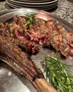 a plate of food with meat on a table at Affittacamere Pizzeria Ristorante Treppì in Caldiero +14 photos