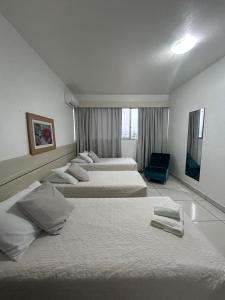 Postel nebo postele na pokoji v ubytování Hotel Comoditá Ltda