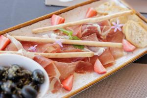 a plate of food with meat and chop sticks at Palmares Signature Apartments in Lagos
