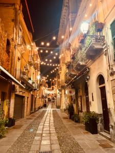 an empty alley with lights in an old building at Ciao Iglesias 2 in Iglesias +7 photos