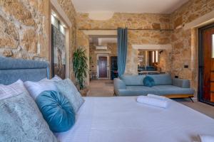 a bedroom with a bed and a living room at Cavos Luxury Apartments in Kissamos