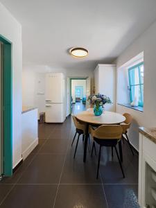 a kitchen and dining room with a table and chairs at Bezdrevská Bašta in České Budějovice +18 photos