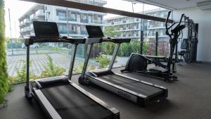a gym with two treadmills in a building at Makia Beach Experience Muro Alto Porto de Galinhas in Ipojuca