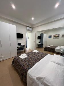 a hotel room with a bed and a desk at BURMARIA APARTMENT and ROOM with garden and jacuzzi in Tropea