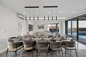 a dining room with a large table and chairs at Villa Magnus in Makarska