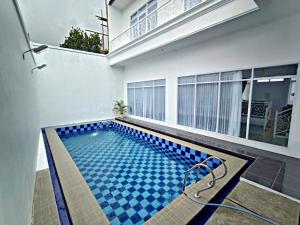 a swimming pool in the middle of a house at Villa Tiara 2 in Cikundul