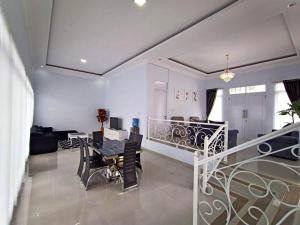 a dining room and living room with a table and chairs at Villa Tiara 2 in Cikundul