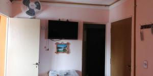 a room with a television on the wall and a door at Casa particular Flavio in Salta +22 photos