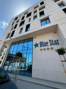 a blue star building with a sign on it at Blue Star Luxury Hotel in Sofia