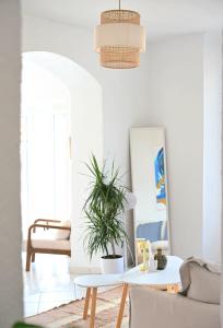 a living room with a table and a potted plant at The Seaside Serenity -NEW AC equipped - Calm with Bay View - Heart of Villefranche in Villefranche-sur-Mer +15 photos