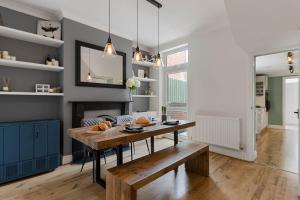 a dining room with a table and a bench at Quayside Haven in Exeter