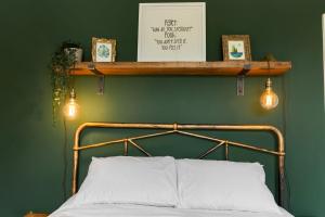 a bed with two lights on a green wall at Quayside Haven in Exeter +43 photos