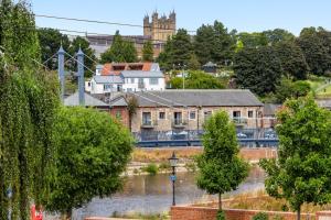 a view of a town with a river and buildings at Quayside Haven in Exeter