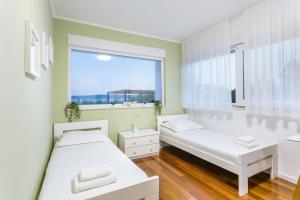 Posteľ alebo postele v izbe v ubytovaní Villa Karmen