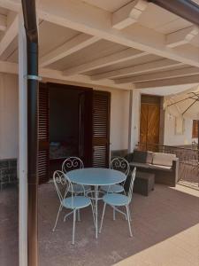 a table and chairs on a patio with a couch at Dal barone in Capo dʼOrlando +26 photos