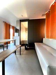 a living room with a couch and a table at Camping Village Tuscia Tirrenica in Tarquinia