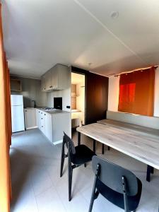 a kitchen with a table and chairs in a room at Camping Village Tuscia Tirrenica in Tarquinia