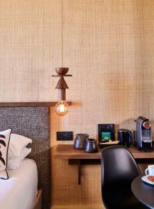 a room with a bed and a desk with a chair at Mercure St Malo Front de Mer in Saint Malo