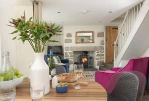 a dining room with a table with wine glasses at Oriel Cottage in St. Agnes