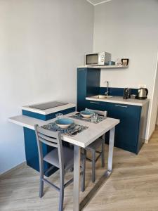 a kitchen with a table and chairs and a counter at Casa al mare Angela in Ventimiglia