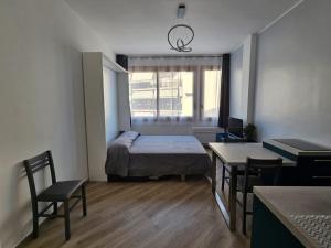 a small room with a bed and a table and chairs at Casa al mare Angela in Ventimiglia